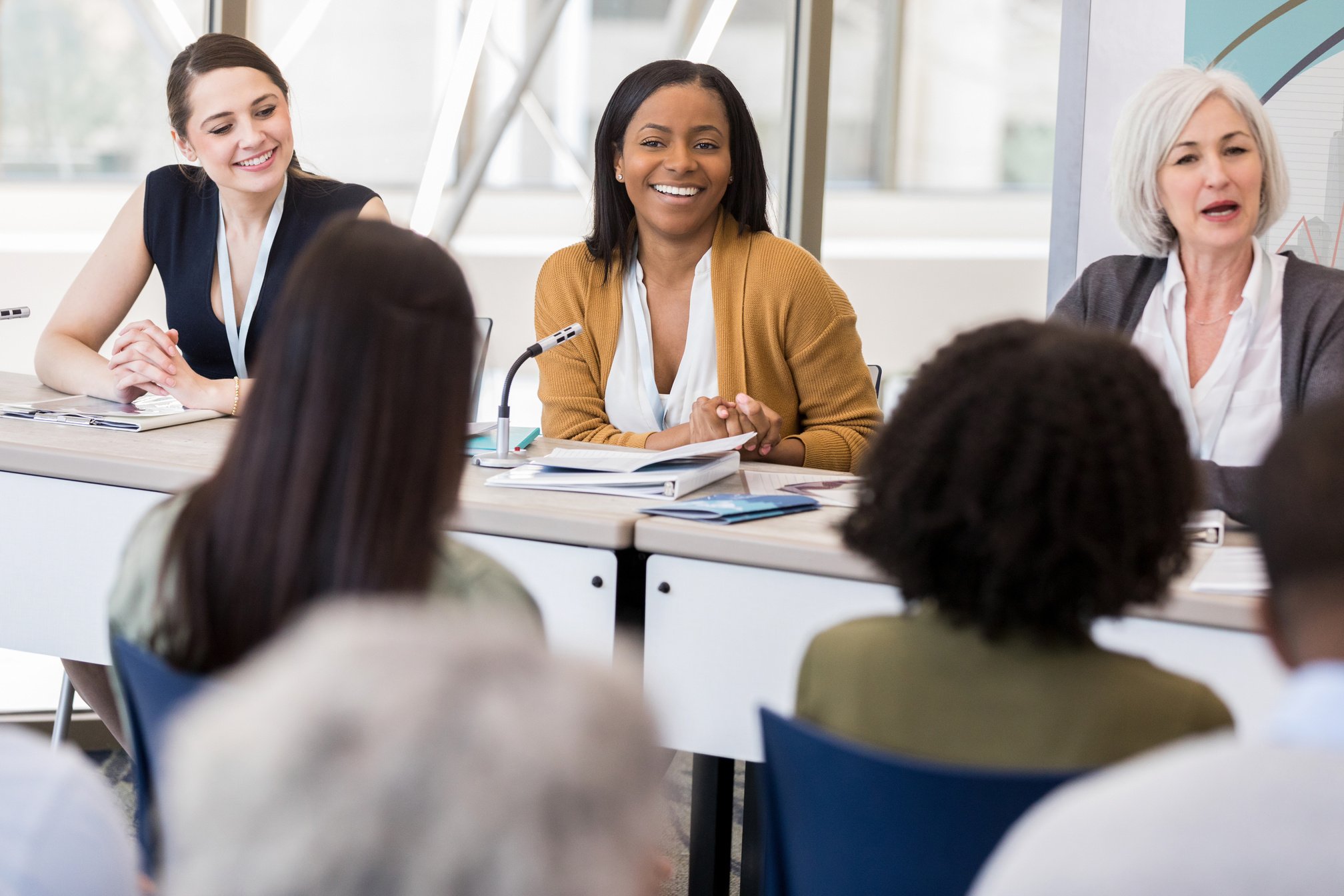 Confident women sit on panel during women's conference